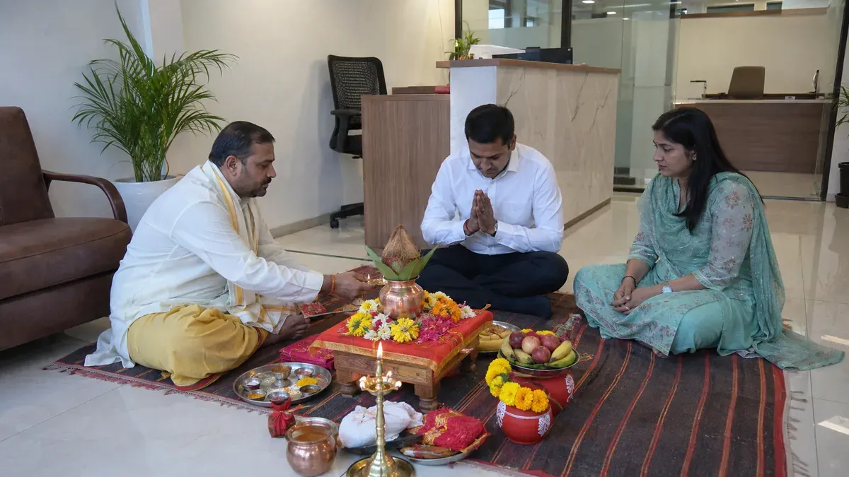 Office staff preparing the ritual area before an office opening puja.